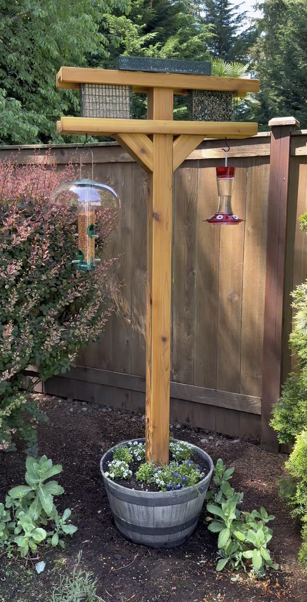 DIY Cedar Bird Feeding Station in whiskey barrel planter